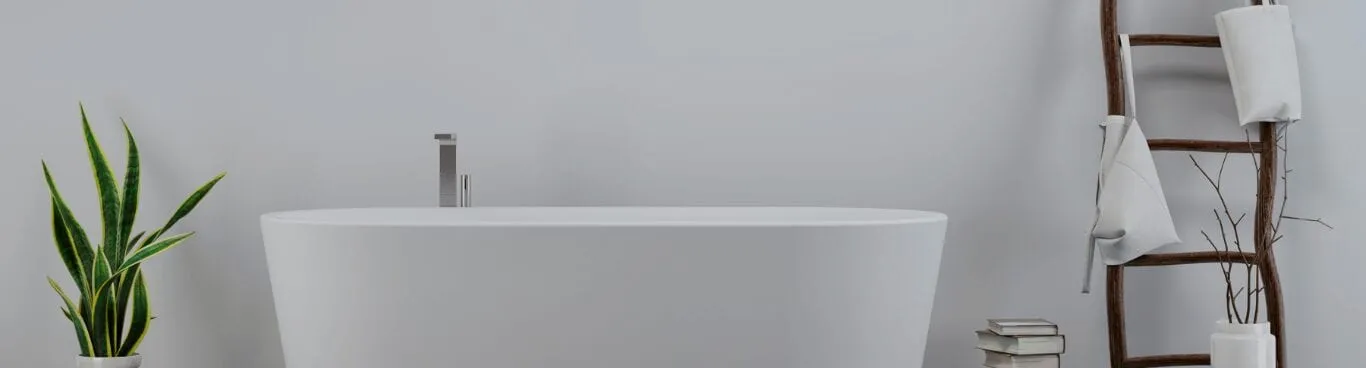 Freestanding white bathtub with a floor-mounted tap