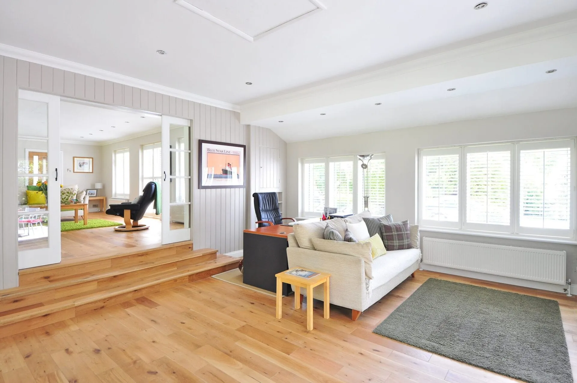 Bright open living room with oak flooring and a white sofa