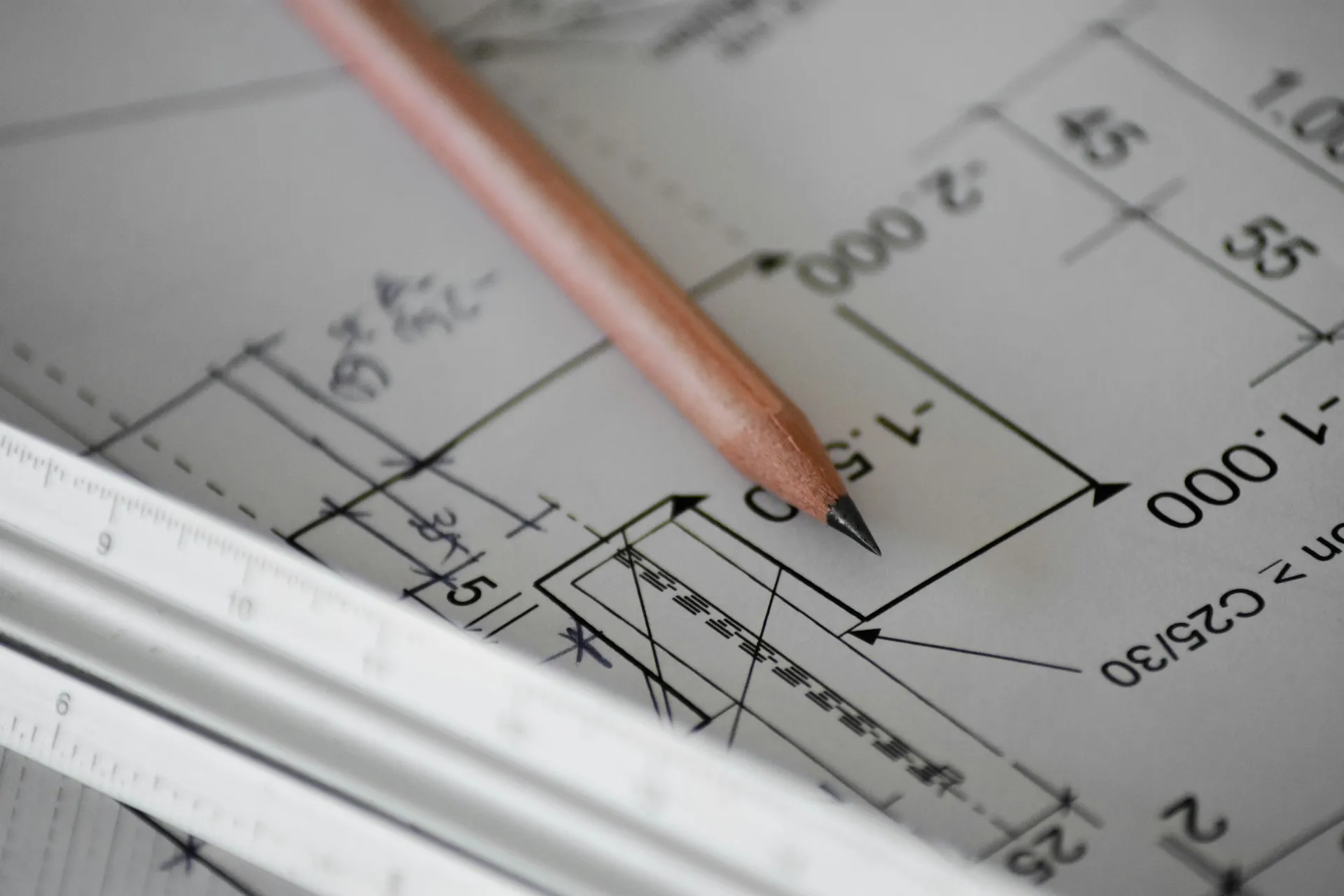 Pencil and ruler on an architectural floor plan drawing