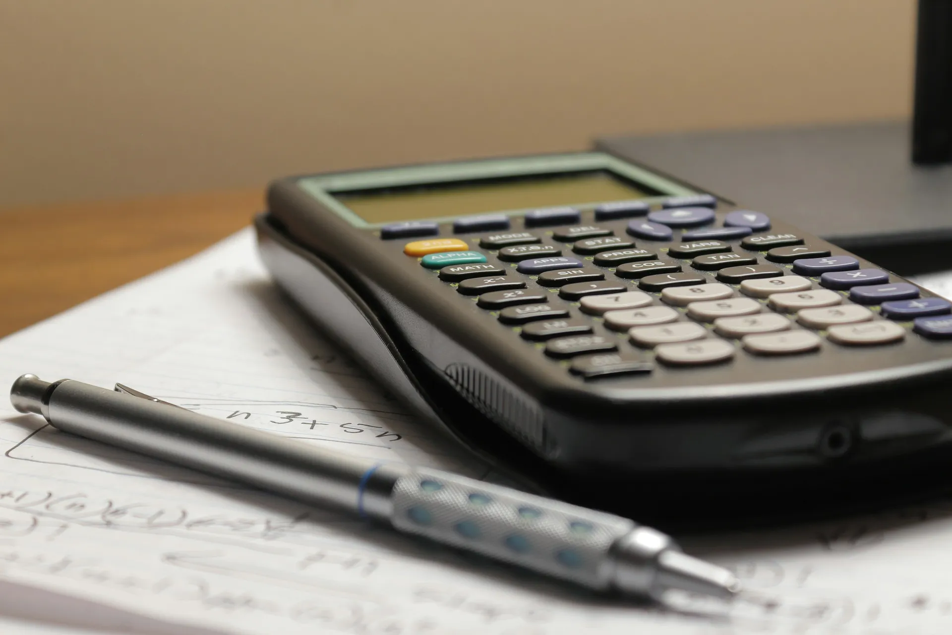 Calculator and pen on top of printed paperwork, comparing renovation quotes