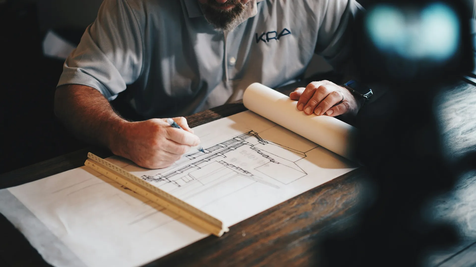Homeowner reviewing a renovation contract with a pen on a wooden table