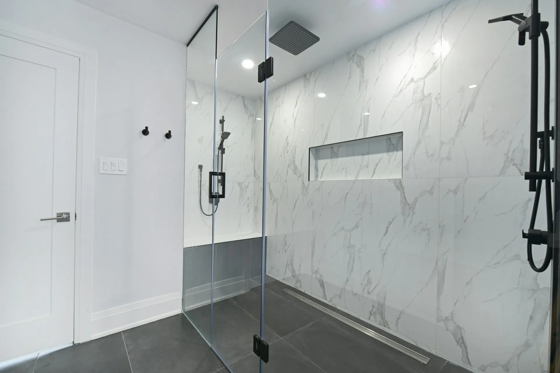 Bright bathroom with a frameless tempered glass shower screen separating the wet and dry areas