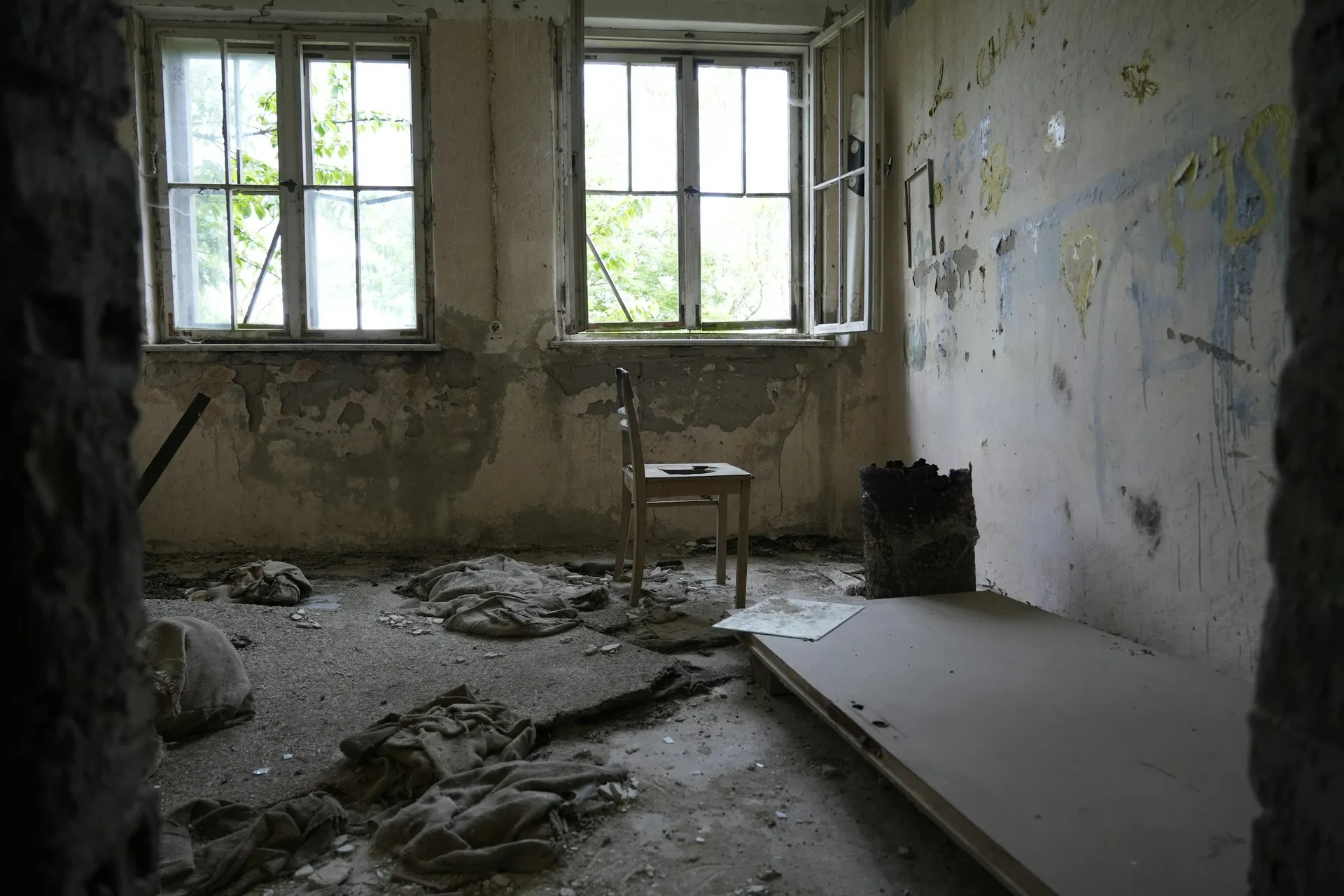 Unfinished room with bare walls and tools left behind after renovation works stopped