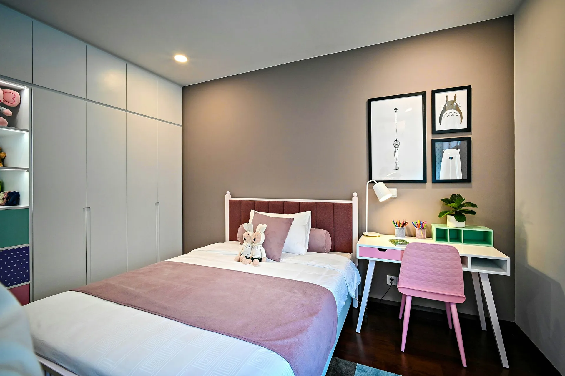 Child's bedroom with a single bed, study desk and full-height white wardrobe