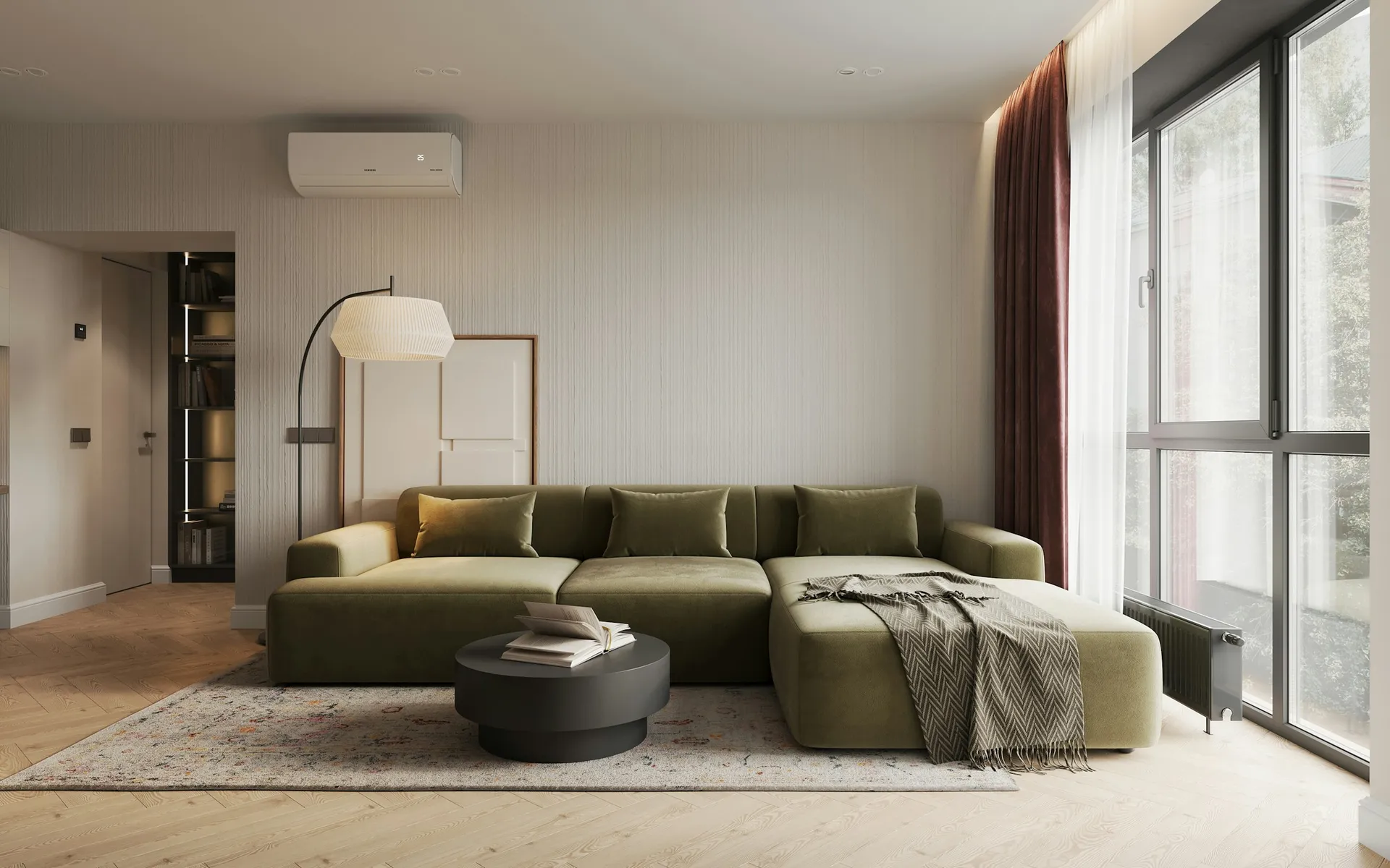 Bright living room with a green sectional sofa and floor-to-ceiling windows