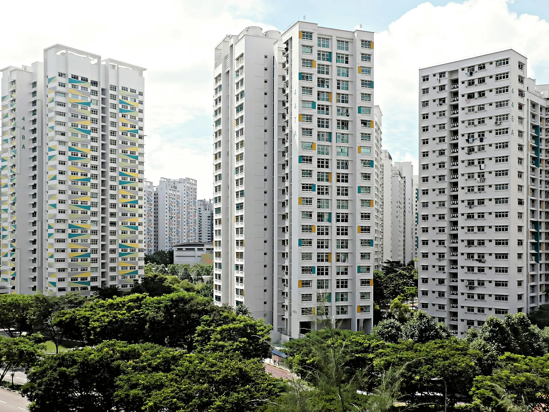 Bright condominium living room with floor-to-ceiling windows overlooking other towers