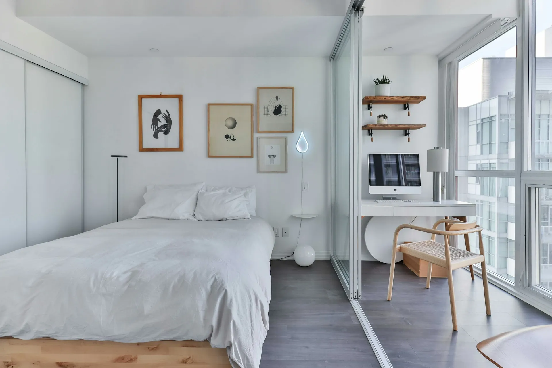 Compact bedroom with a double bed, small desk and full-height window