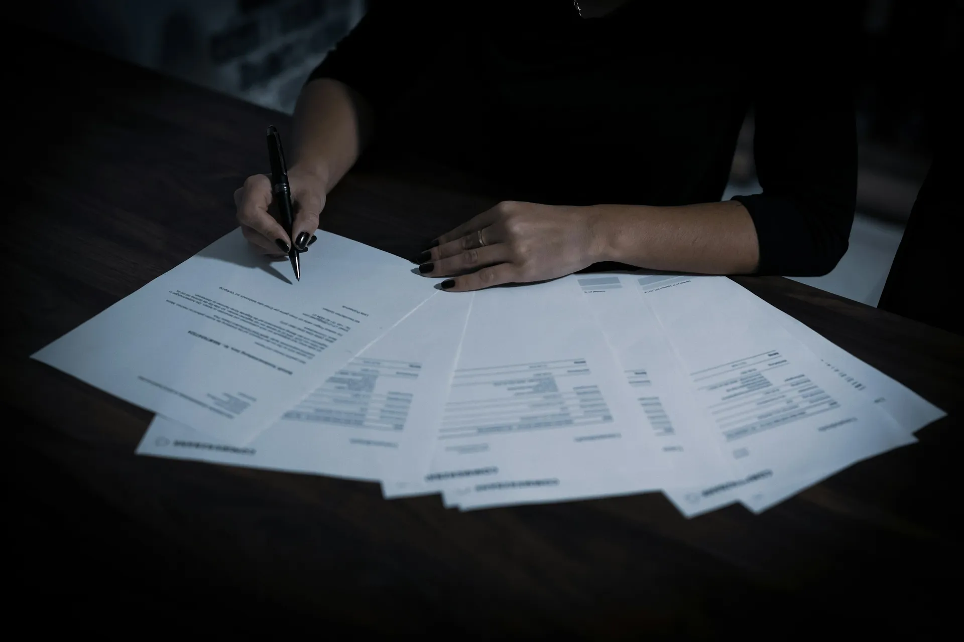 Close-up of a renovation contract with drawings and a pen ready for signing