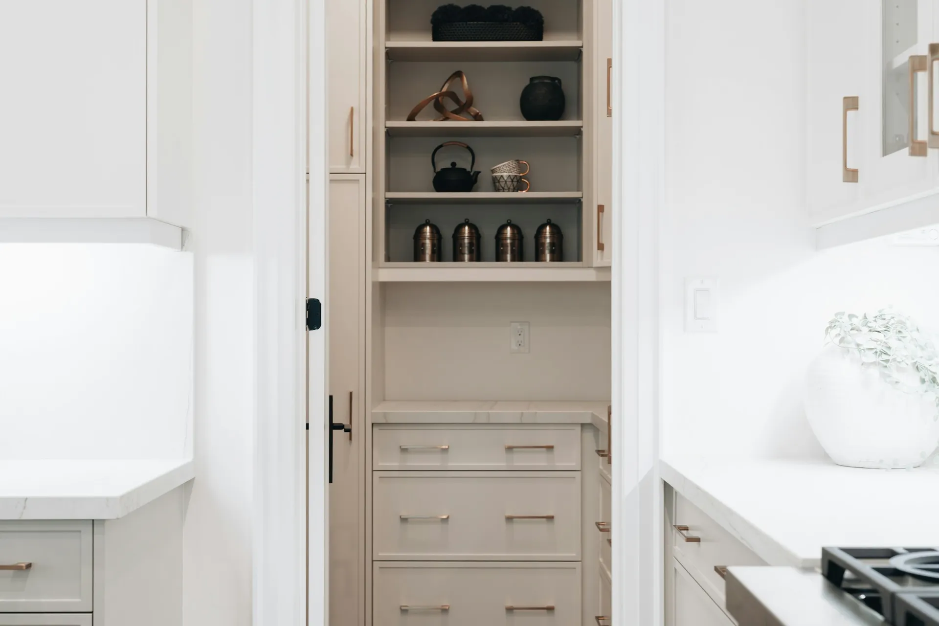 Tall built-in cupboard with open shelves above and drawers below
