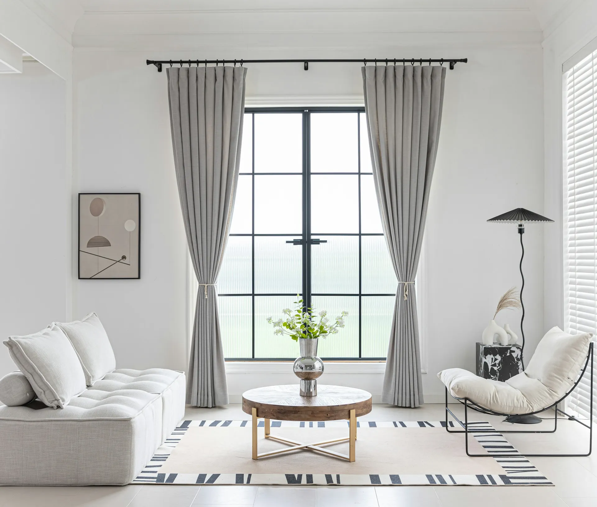Layered sheer and linen curtains filtering daylight in a bright Singapore living room