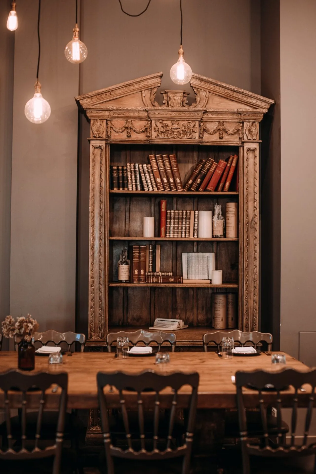 Vintage wooden bookcase filled with books and keepsakes